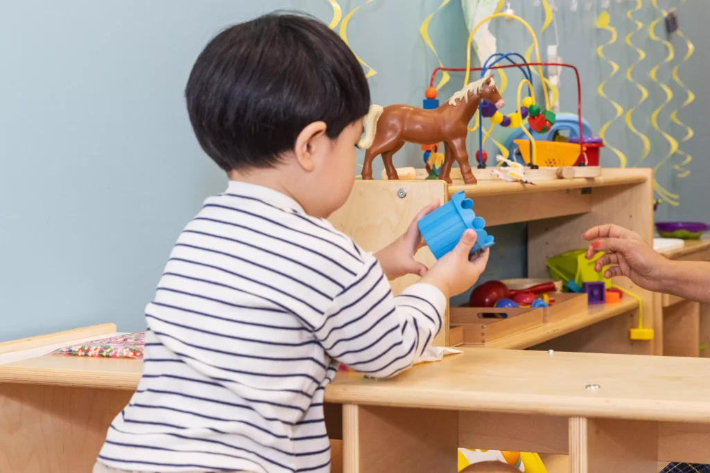 ALT: In Montessori learning, toddlers develop important foundational pre-reading skills"