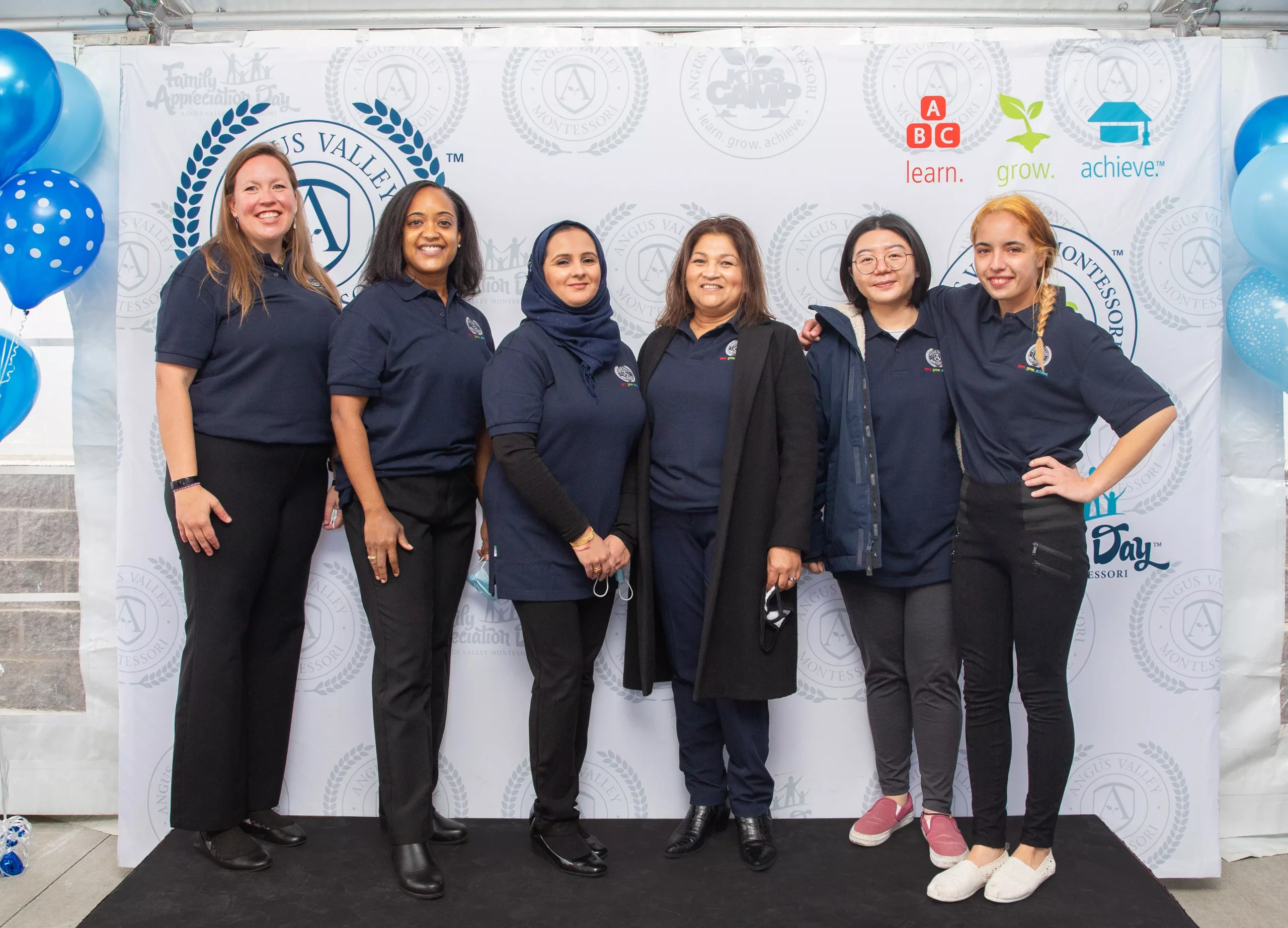 ALT "Educators pose for photo at graduation celebration."